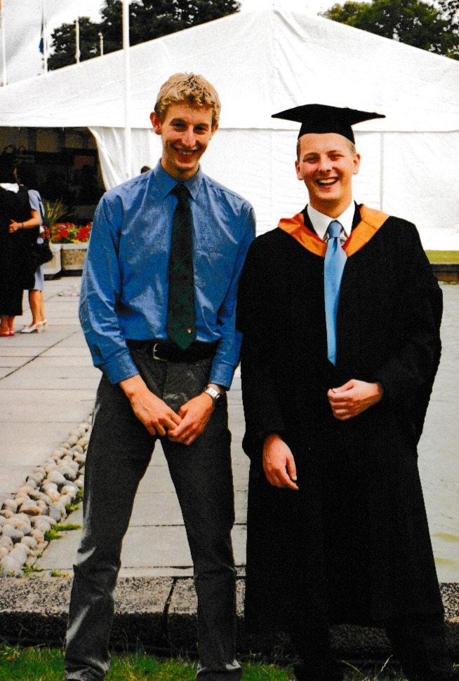 Robbie and Iain stood together at graduation