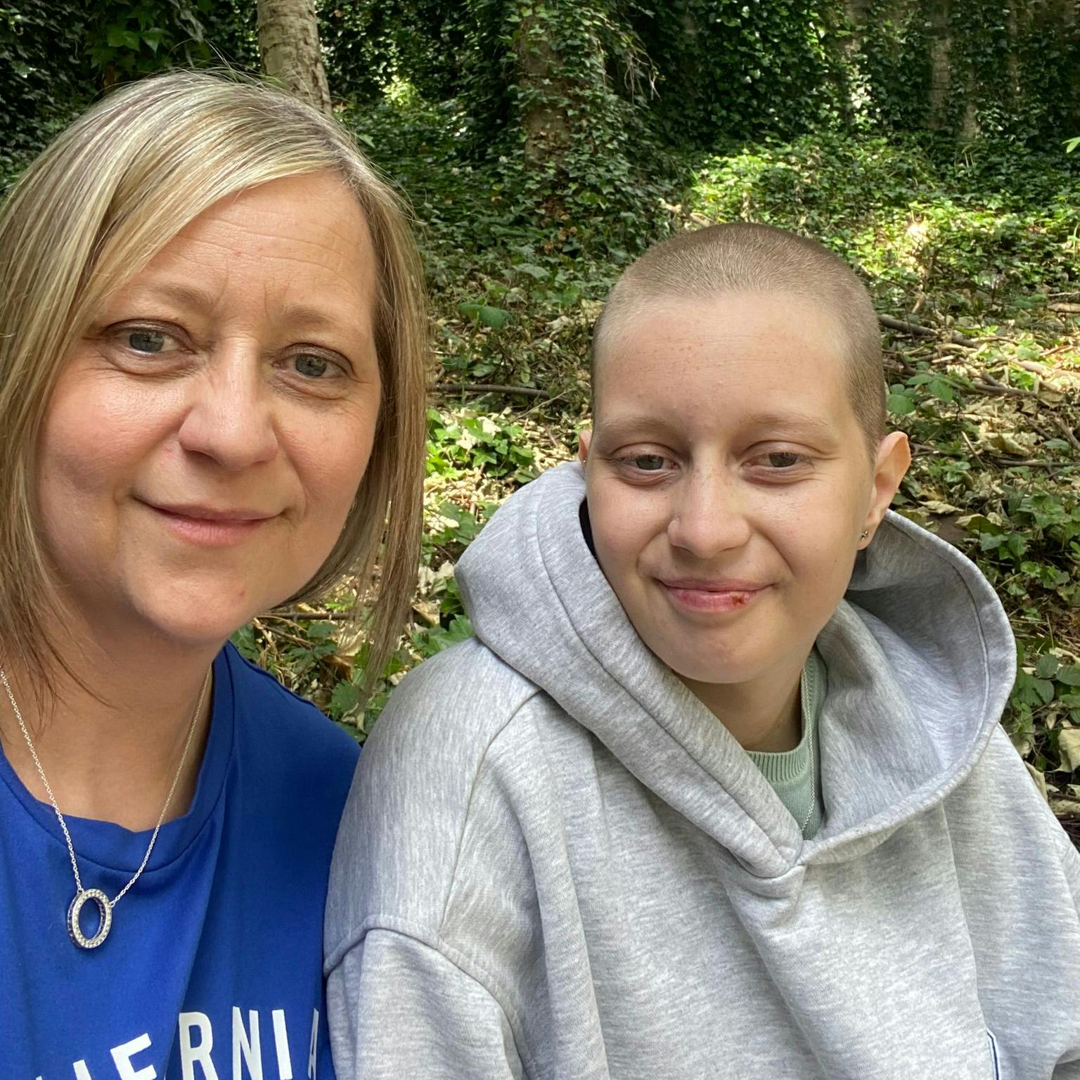Erin in a grey hoodie, sat next to her mum who is wearing a blue t-shirt