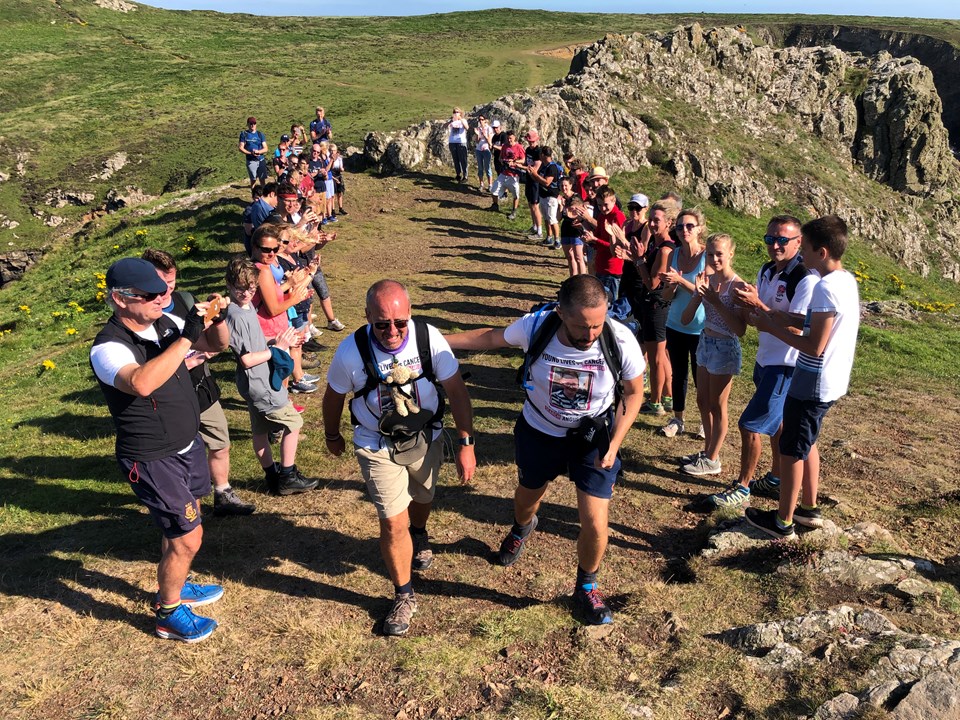 Group of fundraisers completing walk up a hill