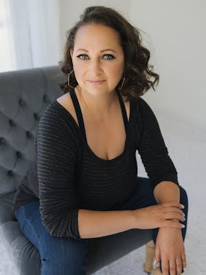 Suzanne Weldy sitting in a chair looking at the camera
