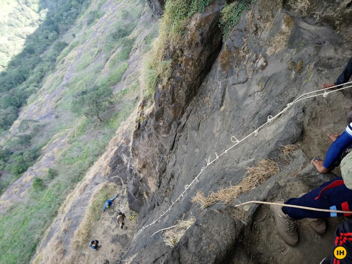 AMK Trek - The 90° vertical rock face. The belayer is ready below and trekkers standby for instructions - Indiahikes - Nitesh Kumar