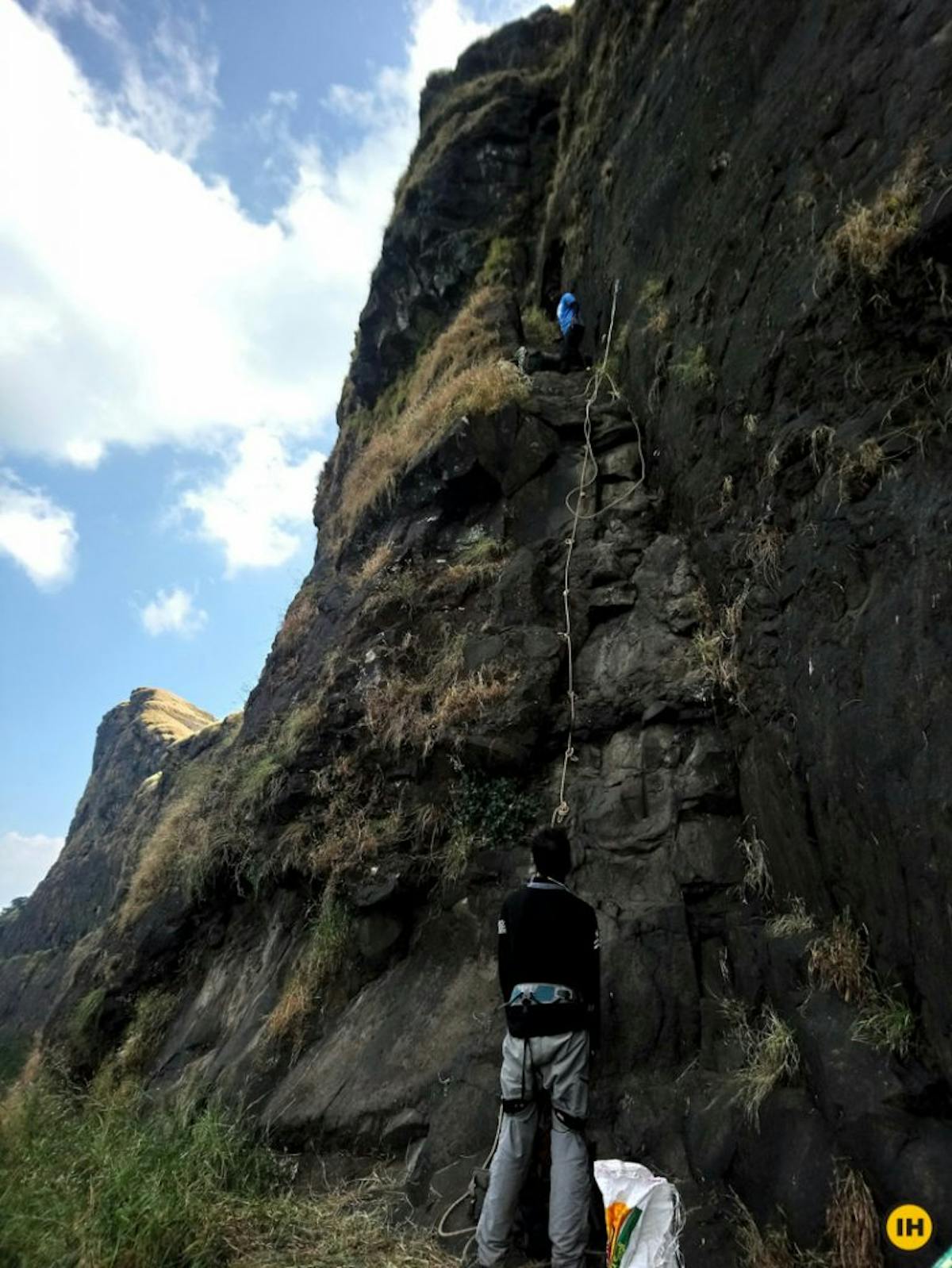 AMK Trek - Trekkers descend down the rock face while the belayer oversees from the bottom - Indiahikes - Nitesh Kumar
