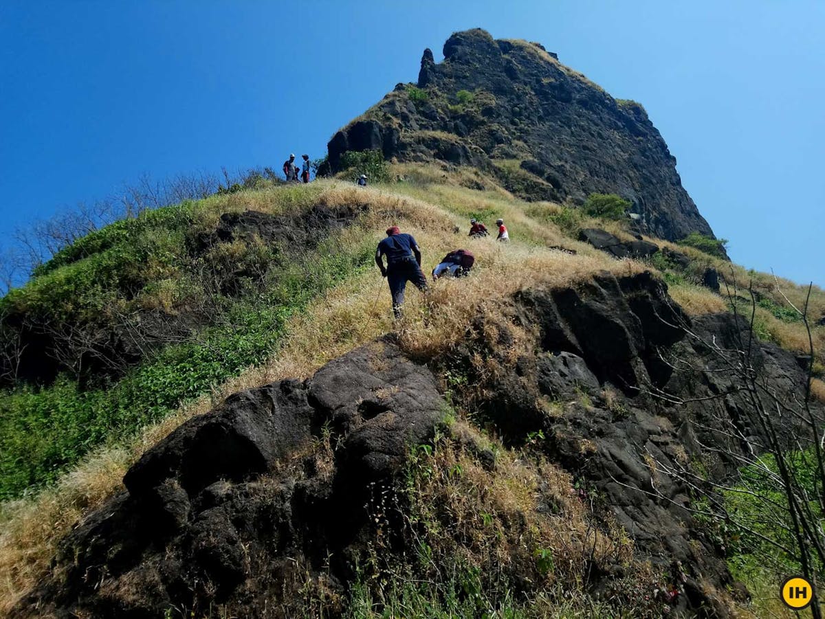 AMK Trek - Guide helping with the ropes while the trekkers descend holding them - Indiahikes - Nitesh Kumar