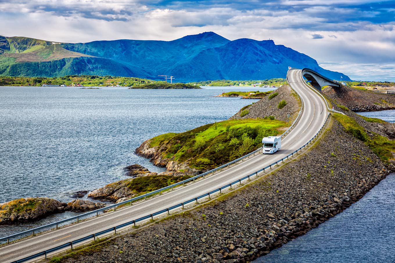 Campervan driving on the road surrounded through Norway's nature