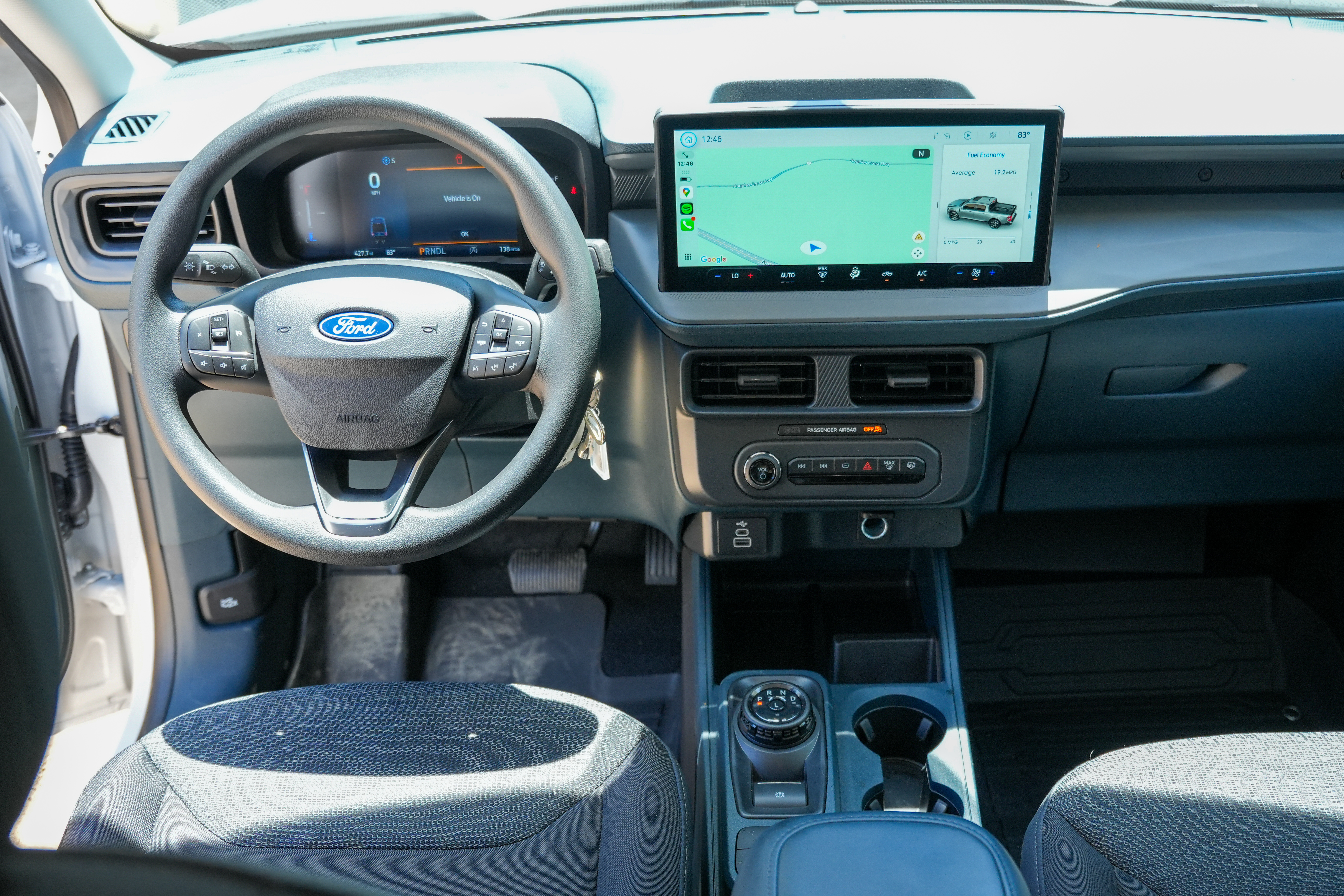 Modern Ford vehicle cockpit with digital dashboard, touchscreen navigation system, and comfortable driver and passenger seats.