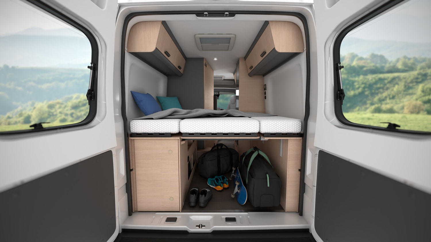Rear view of van interior showing bed, overhead cabinets, and under-bed storage with shelves and bags.