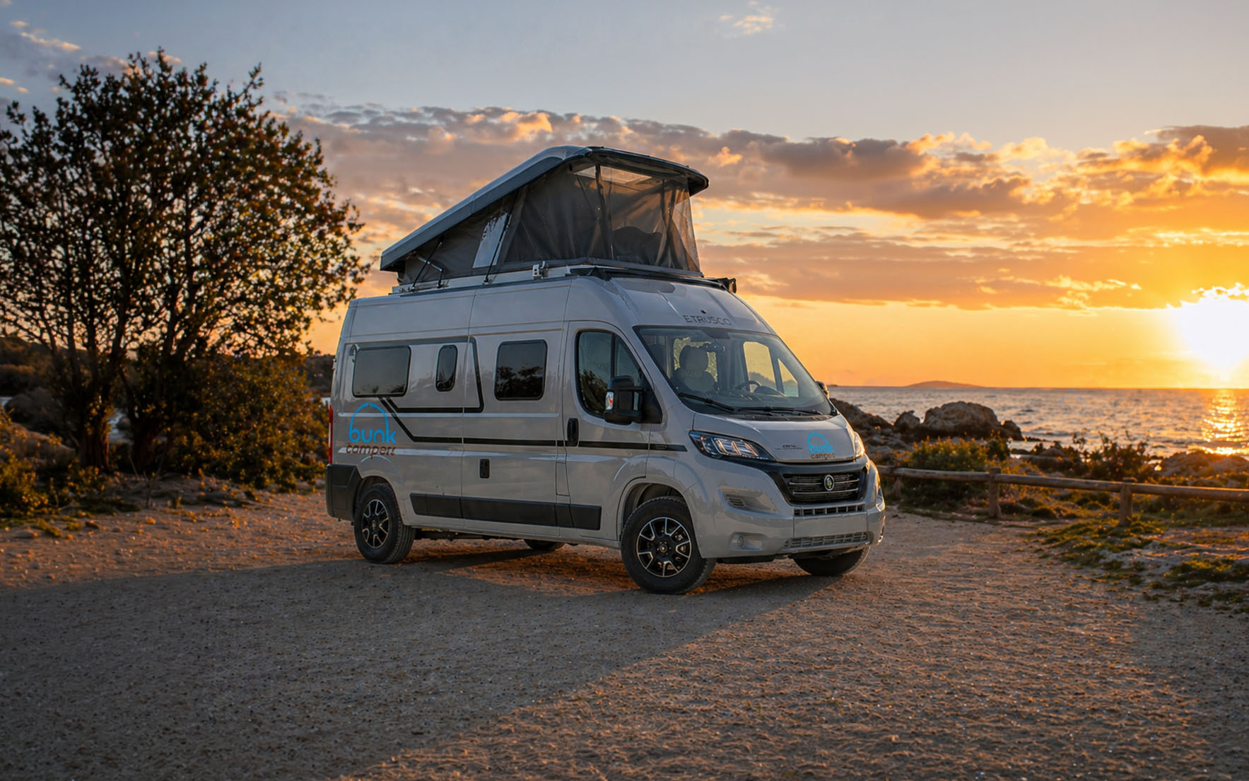 Medium camper van side view with raised roof tent.