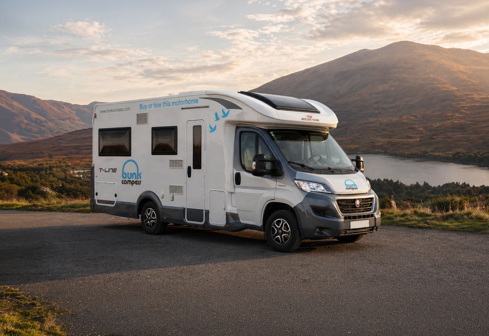 Front and side view of a large camper van with a high roof, no roof tent visible.