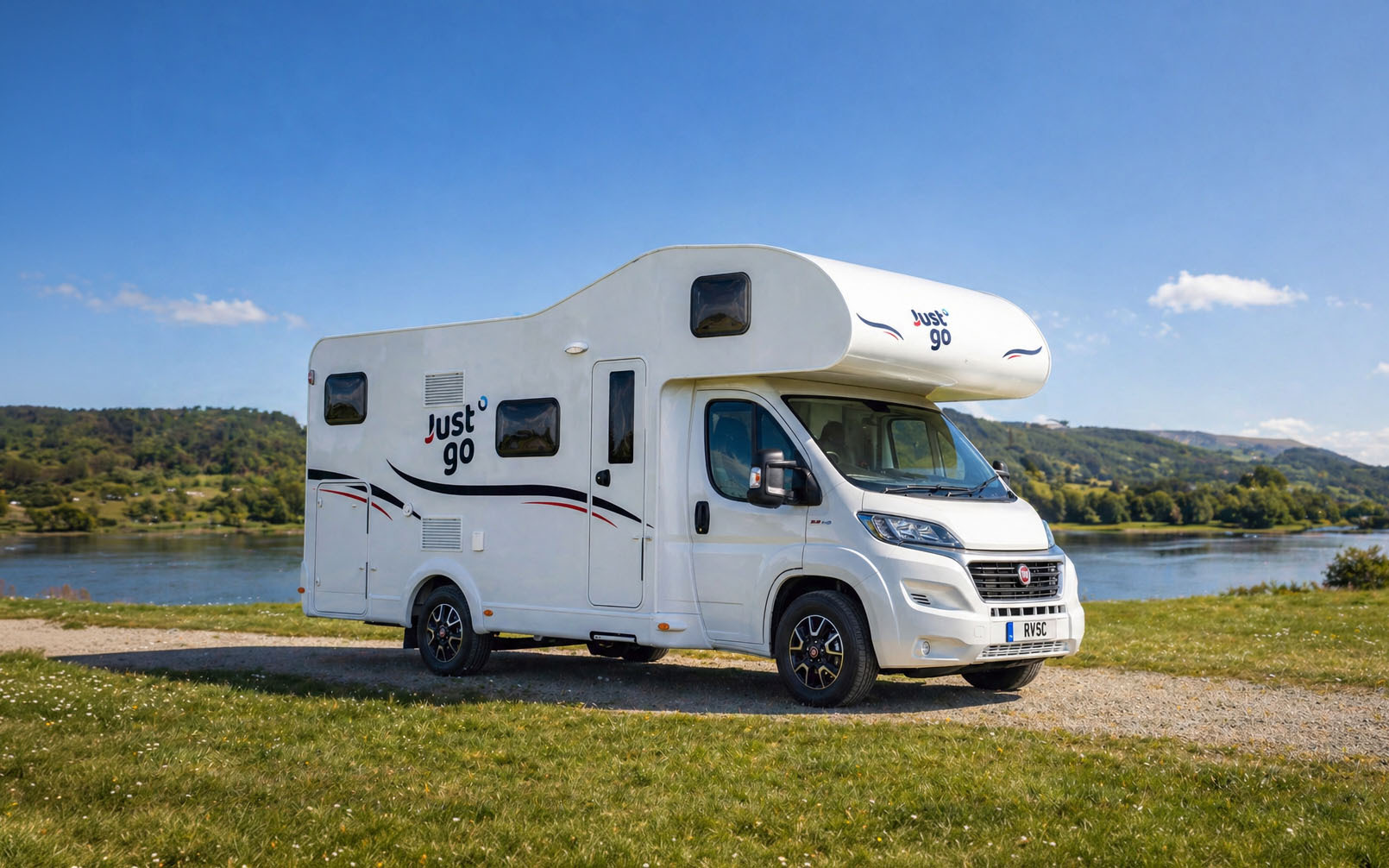 Large camper van side view, over-cab sleeping area, mid-size body, no roof tent.