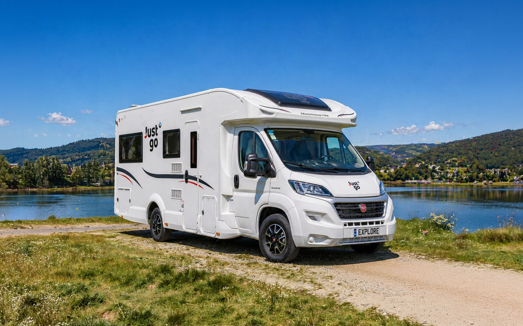 Front side view of large white camper van with high roof, long wheelbase, and no roof tent.