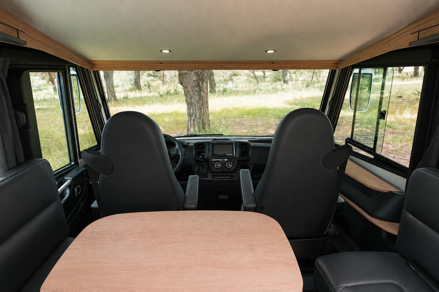 Van interior with two front seats, a central table, side bench, storage compartments, and visible dashboard.