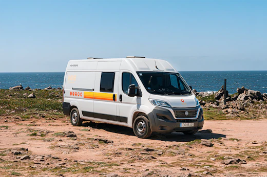 Medium-sized campervan, front and side view, high roof, sliding side door, no roof tent.