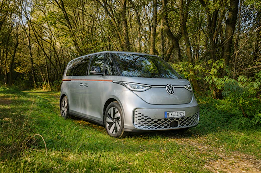 Front-side view of a medium-sized silver campervan without a roof tent.