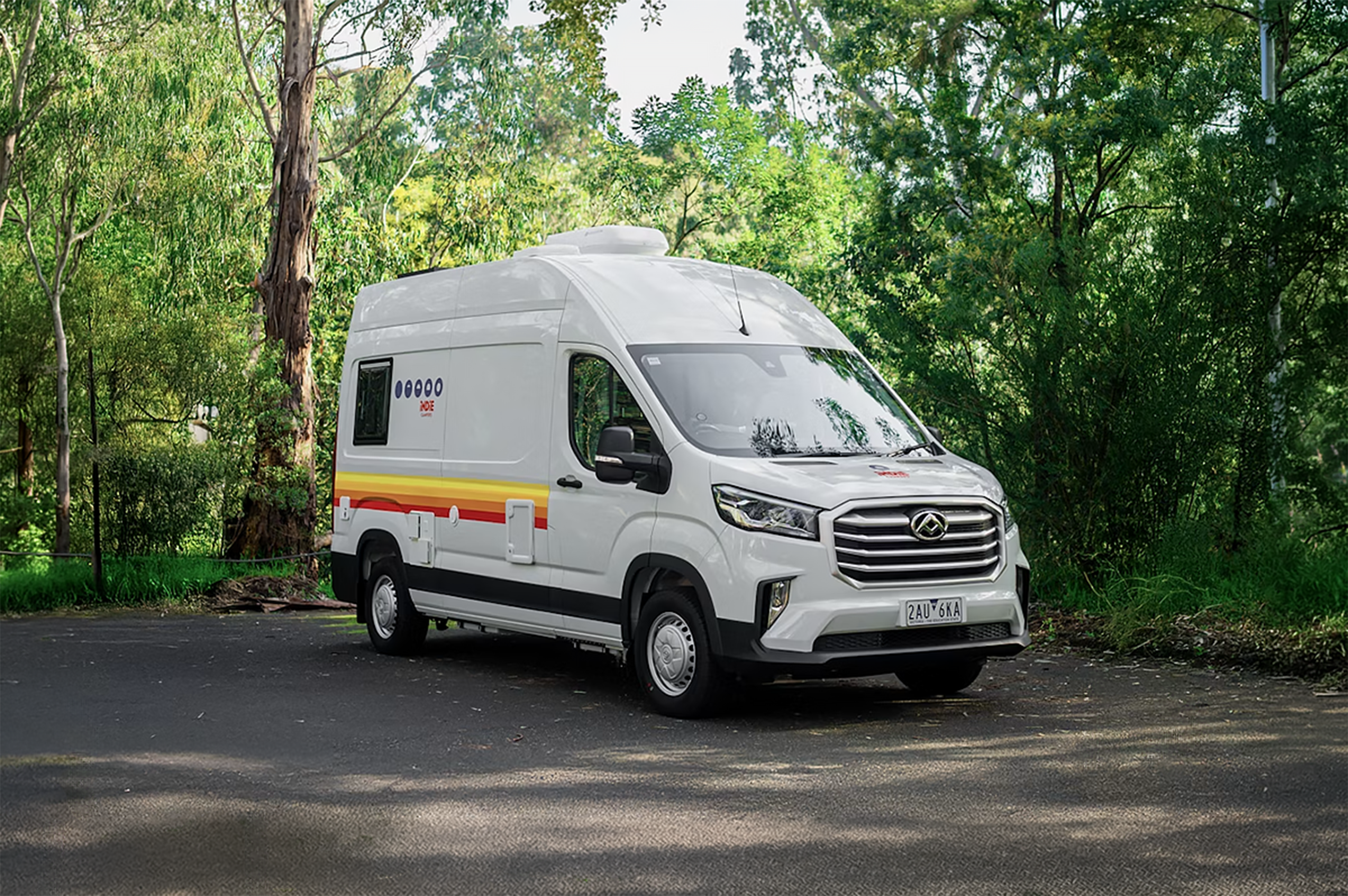 White medium campervan, front-side view, high roof, no roof tent, standard length wheelbase.