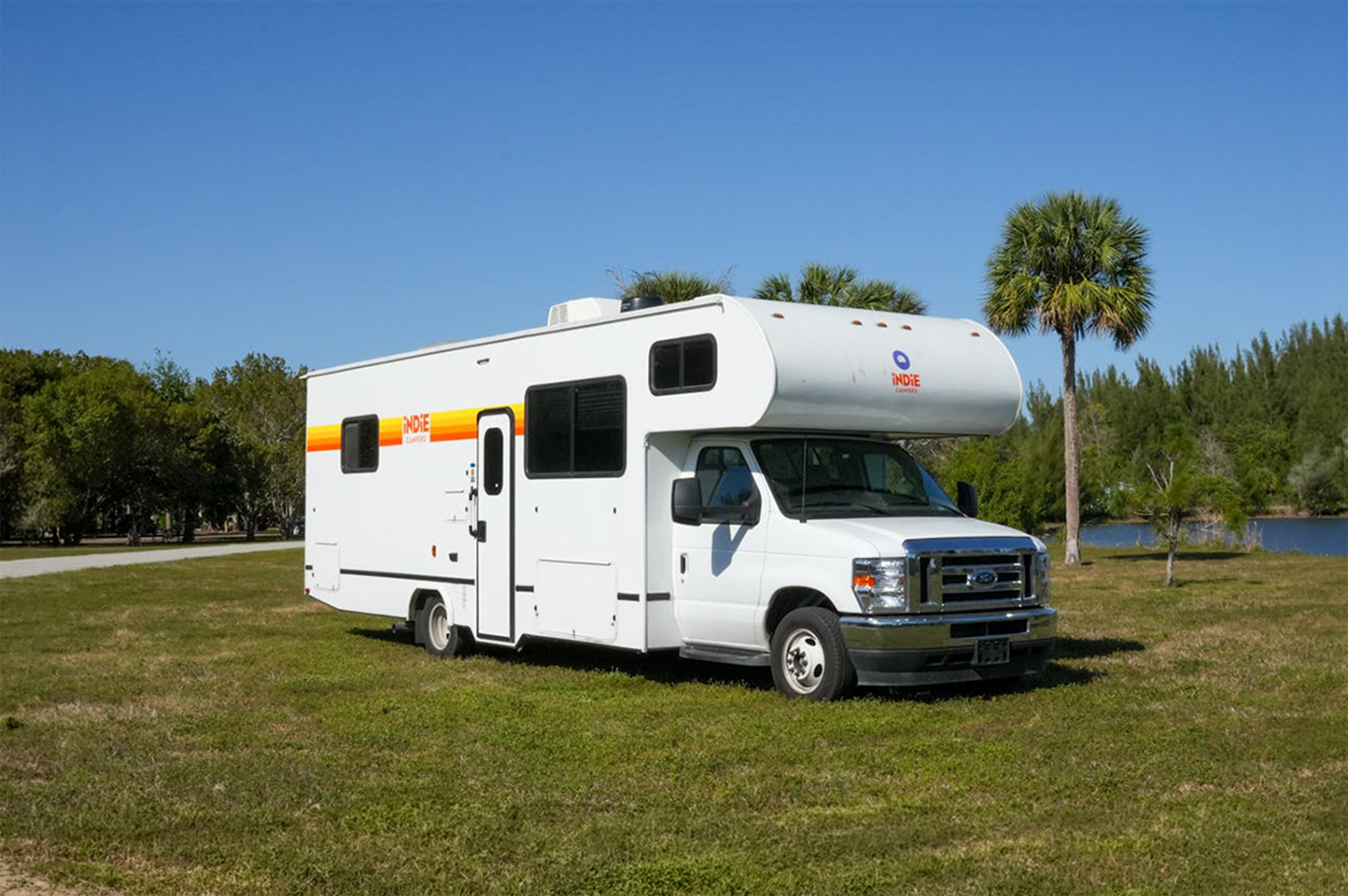 Large motorhome side and front view, overcab sleeping area, mid-size layout, no roof tent visible.