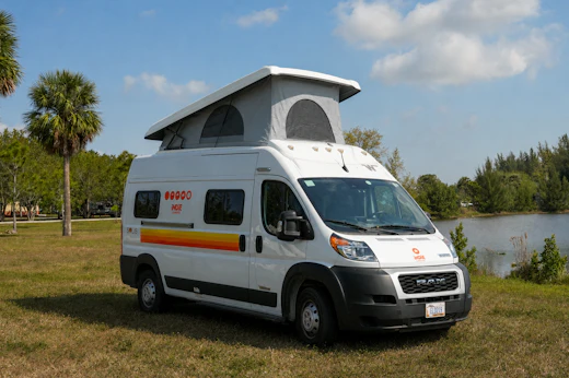 Front-side view of a medium campervan with raised roof tent.