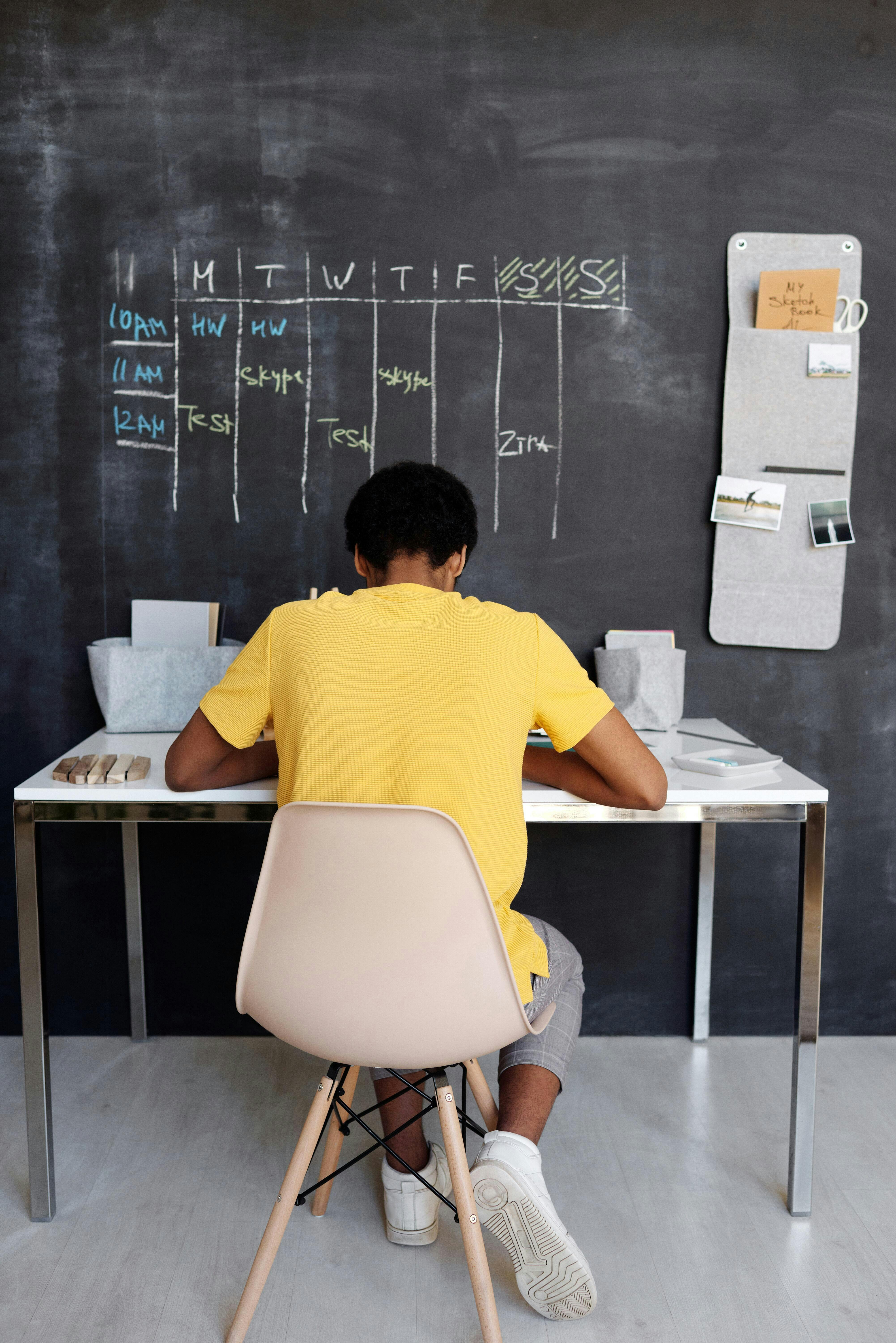 Man with a computer and a blackboard