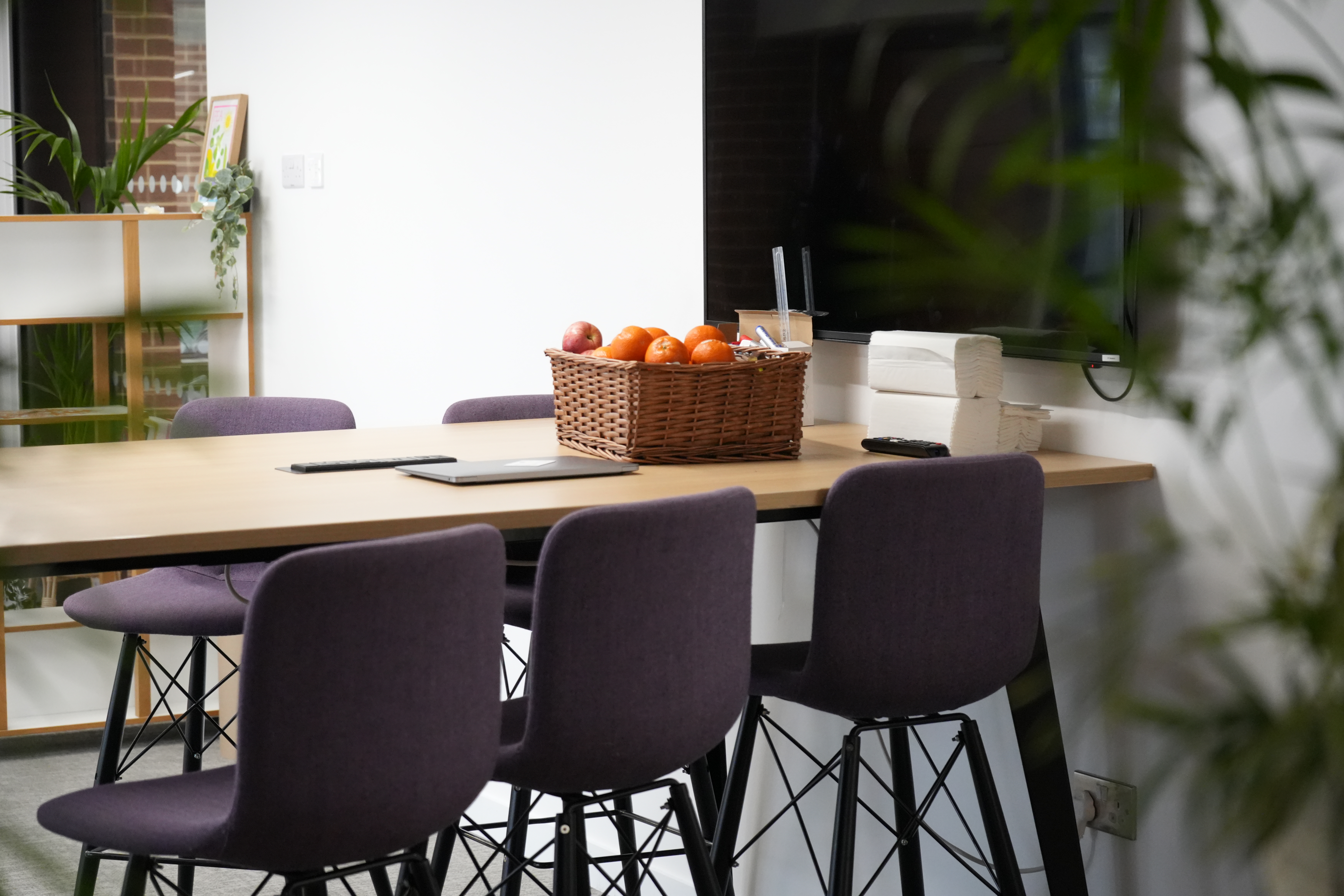 A table with a basket of fruits on it