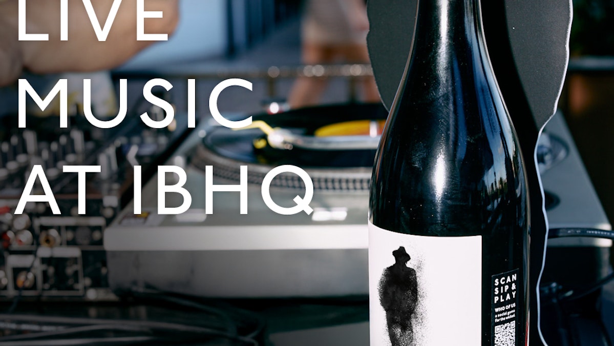 bottle in front of DJ turntables