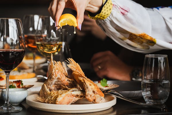 lemon juice dripping on barramundi wings