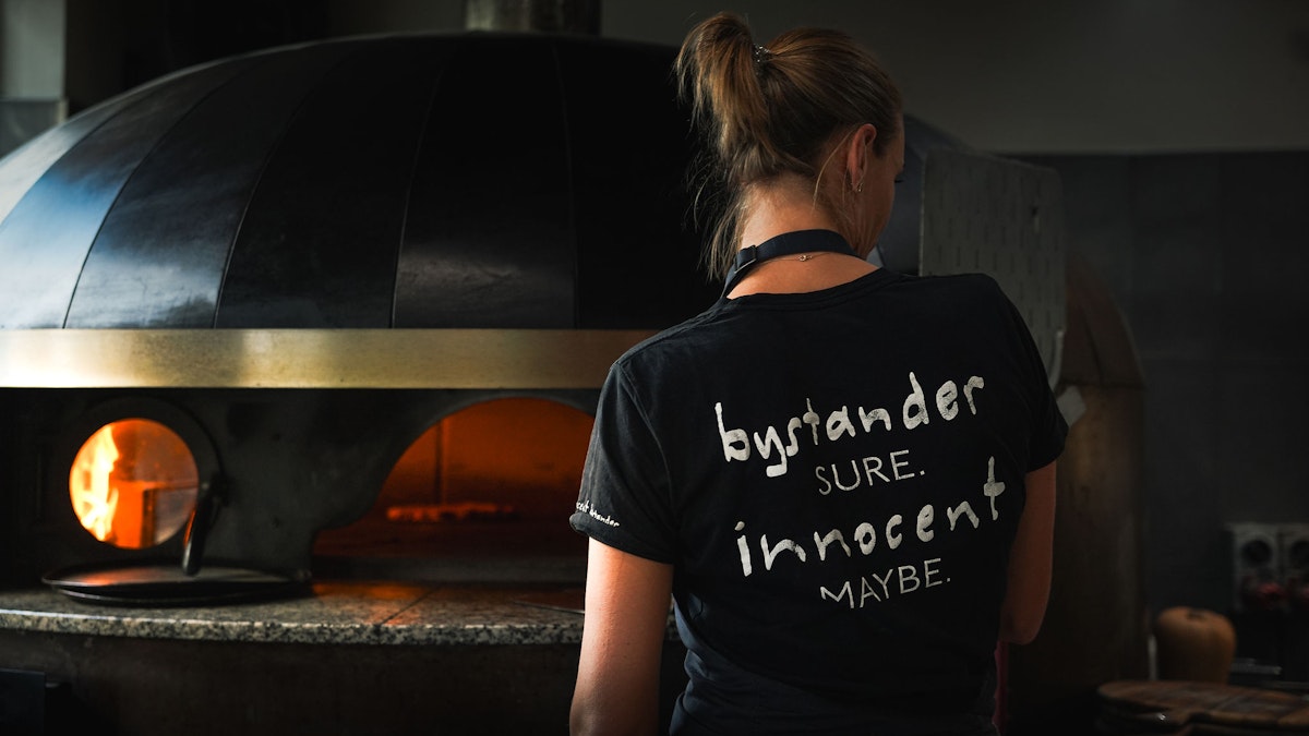 G in front of the pizza oven