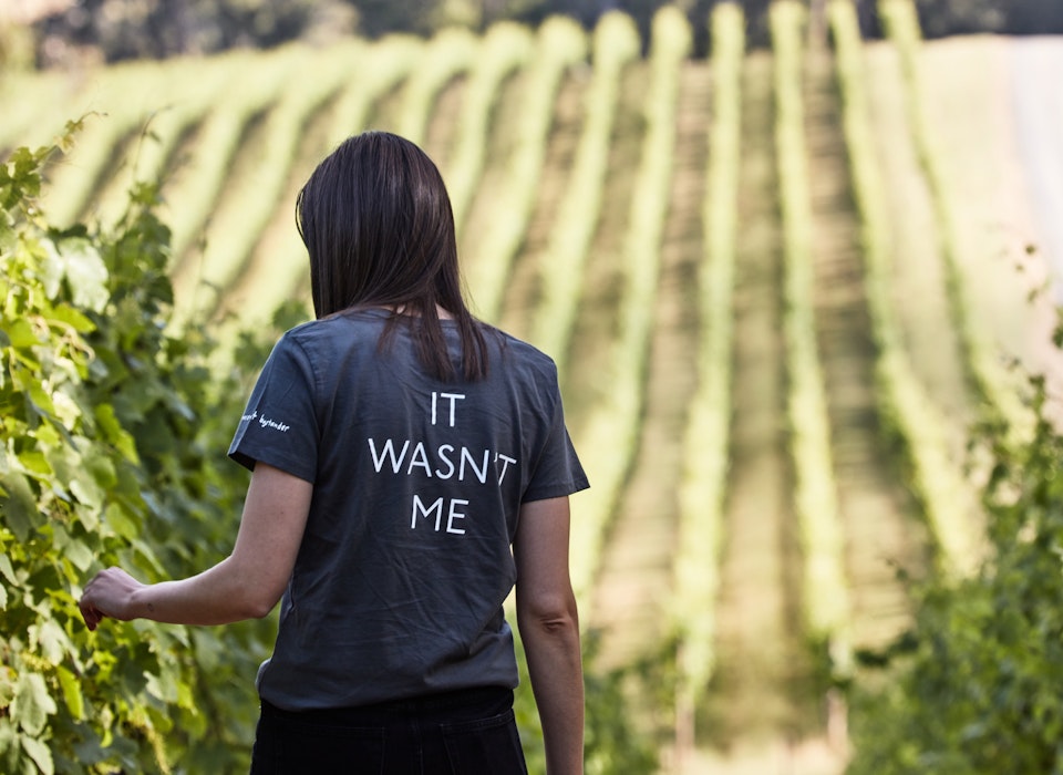 Girl walking through a vineyard in the Yarra Valley