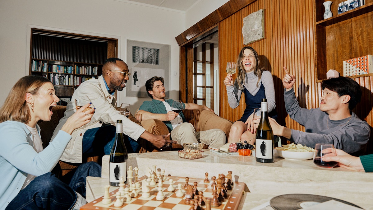 A group of friends enjoying food and wine at home