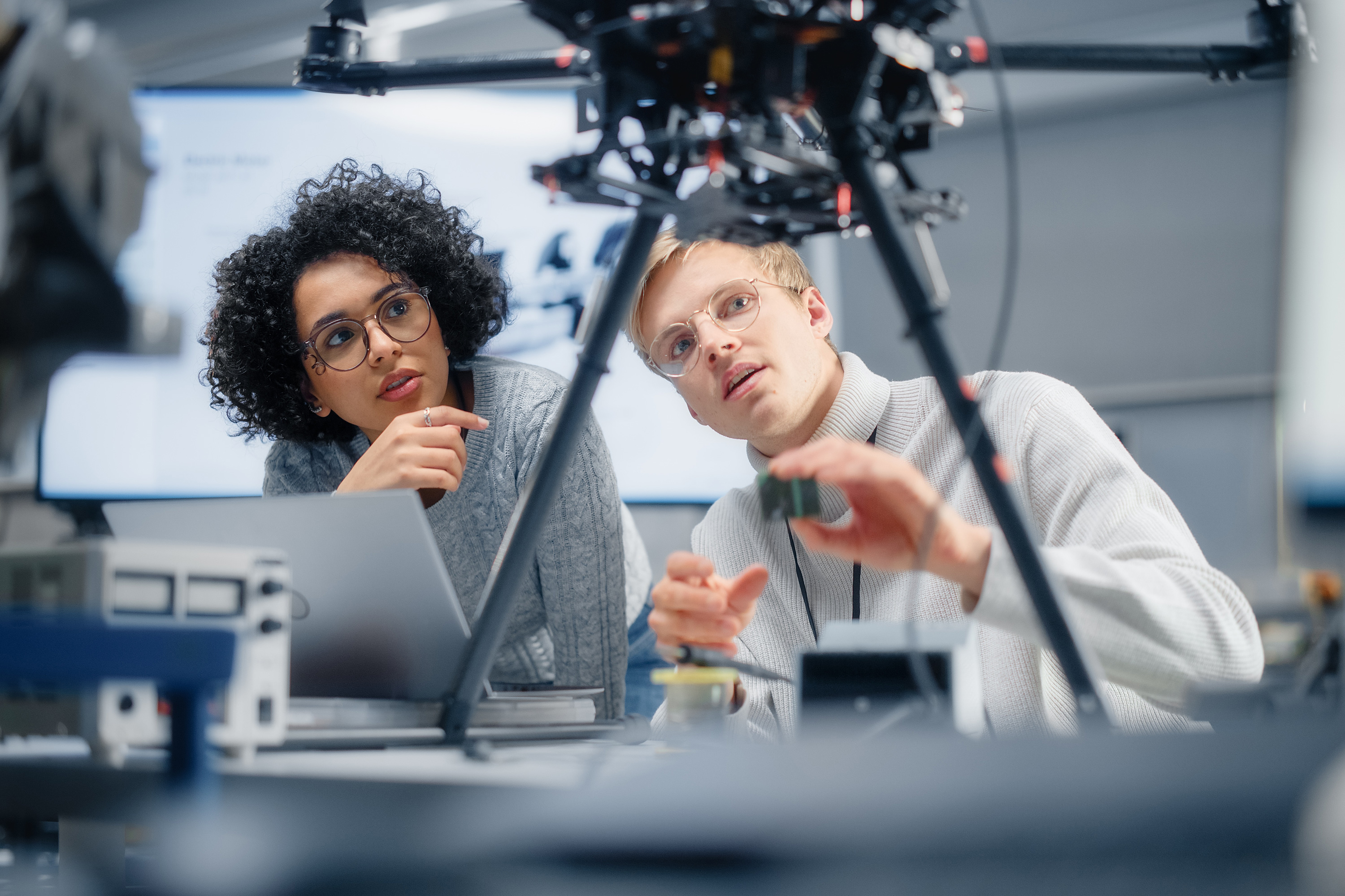 Engineer working on a robotic system in a laboratory, representing innovation and advanced manufacturing.