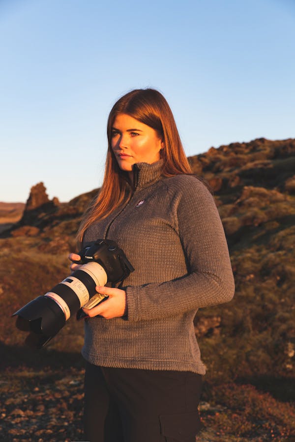 Picture of geologist Helga Kristin Torfadottir with a camera