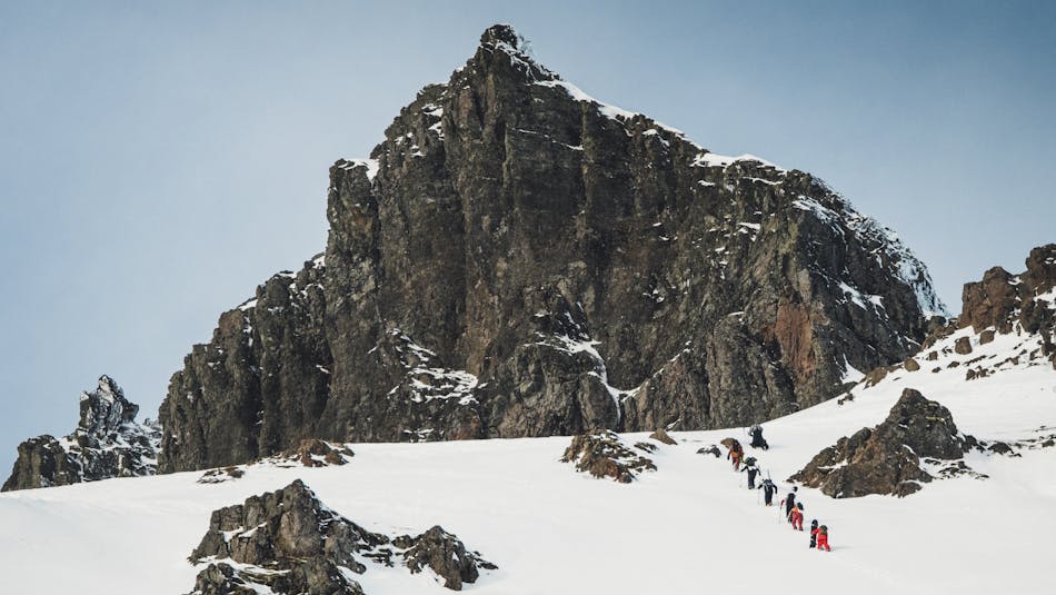 Skiers and boarders ascending at Austurland Freeride Festival 