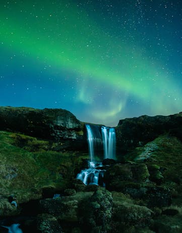 The Northern Lights over a waterfall