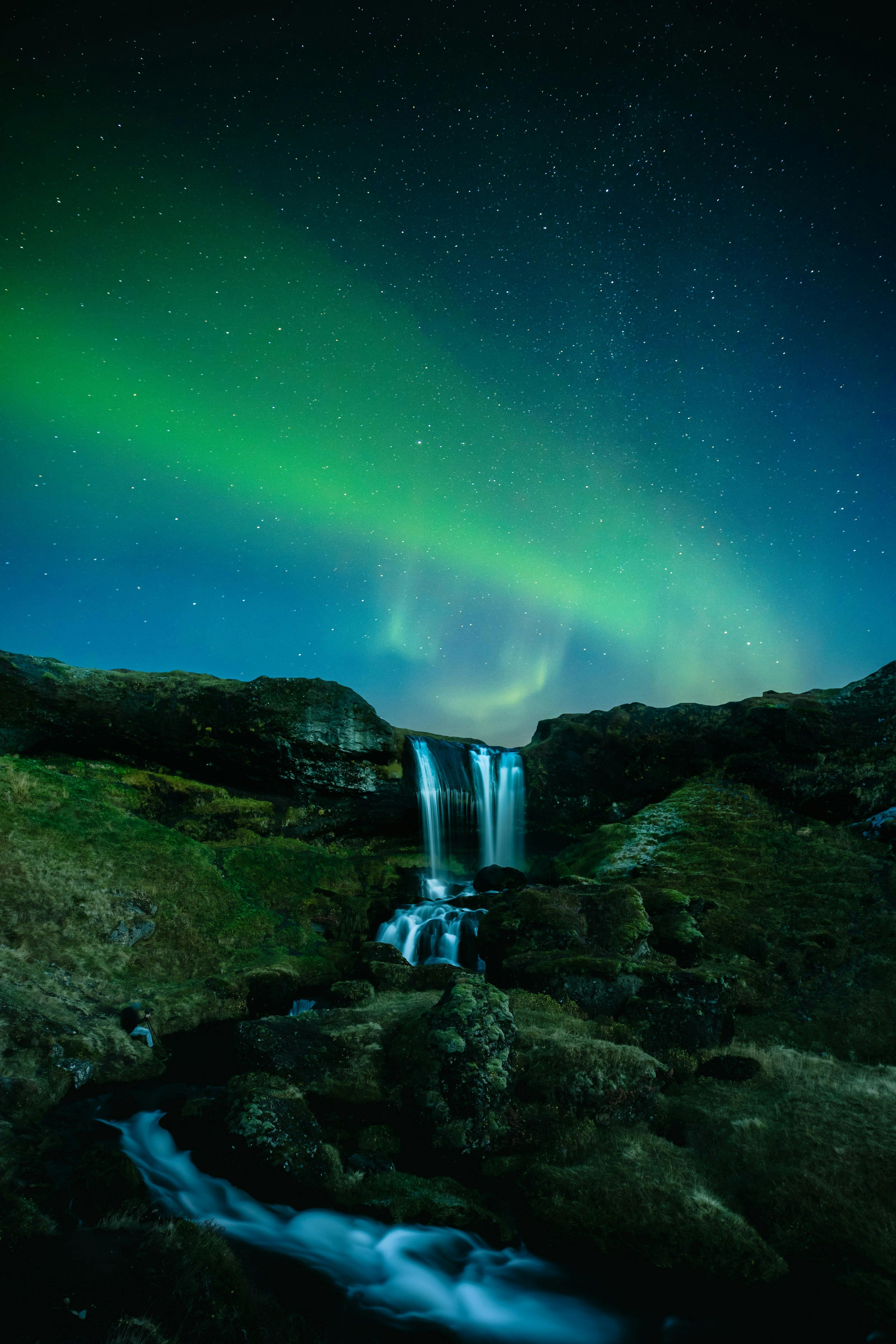 Northern lights over a waterfall