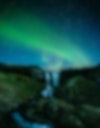Northern lights over a waterfall