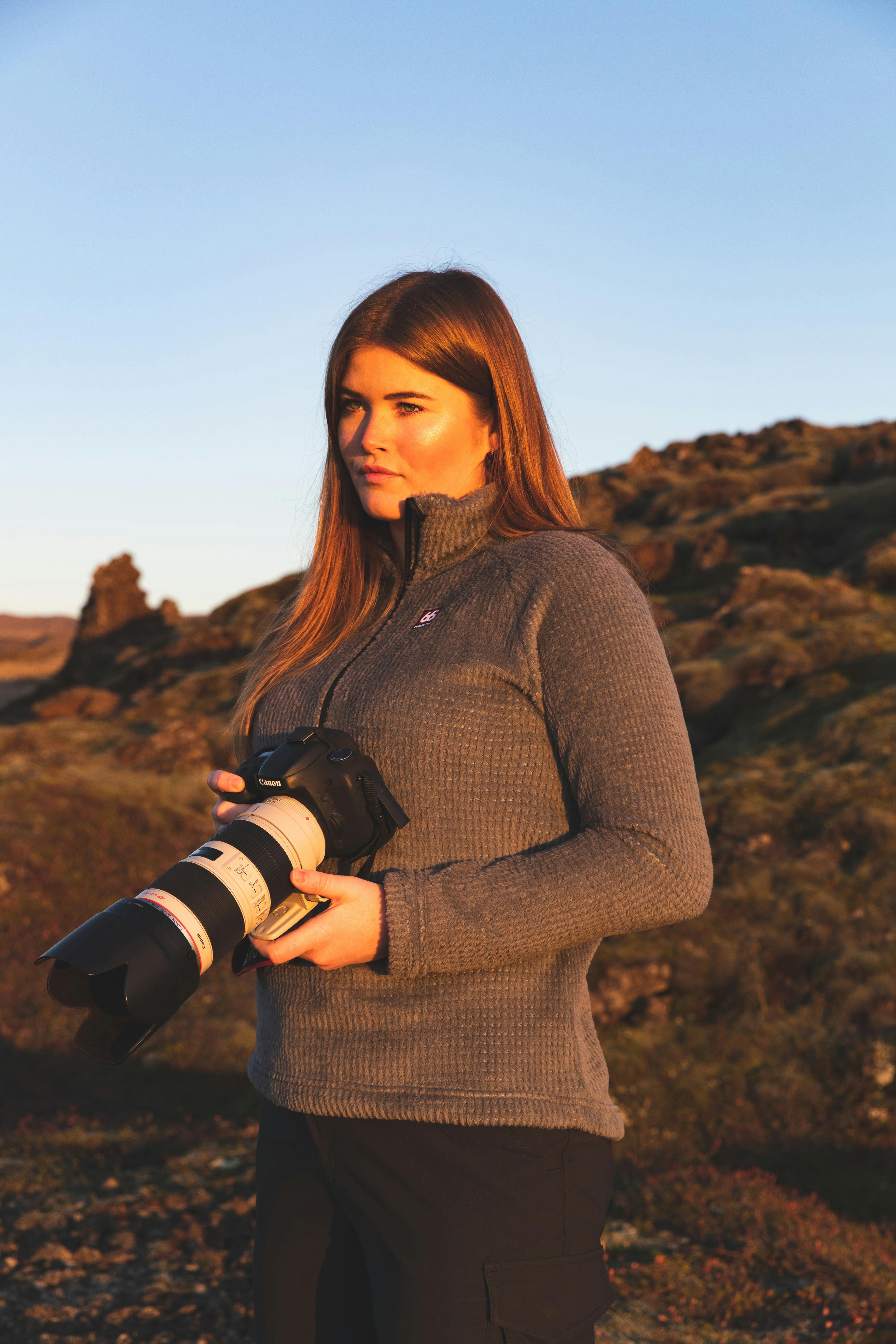 Picture of geologist Helga Kristin Torfadottir with a camera