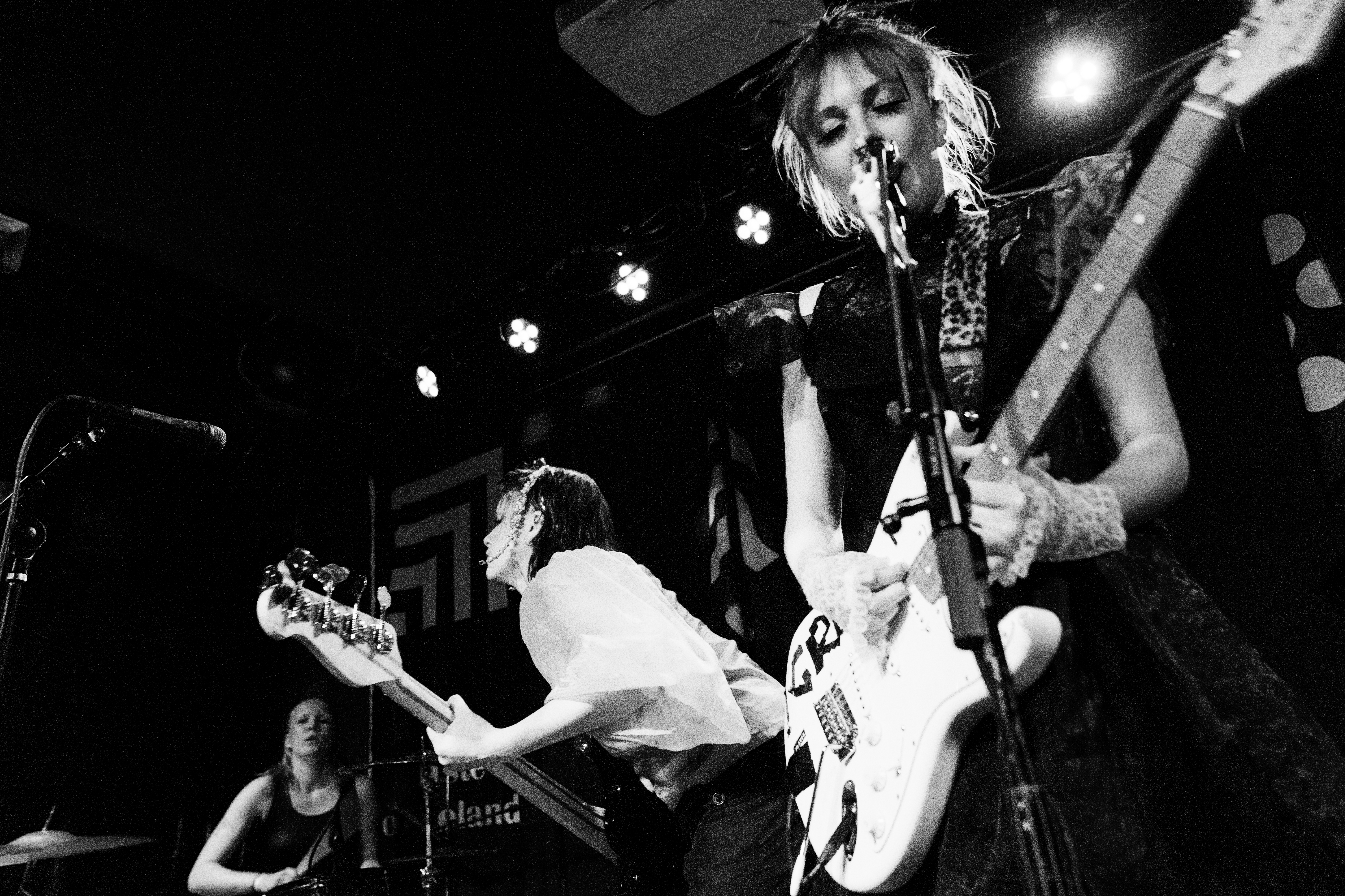 A black and white image of Icelandic punk trio GROA playing live