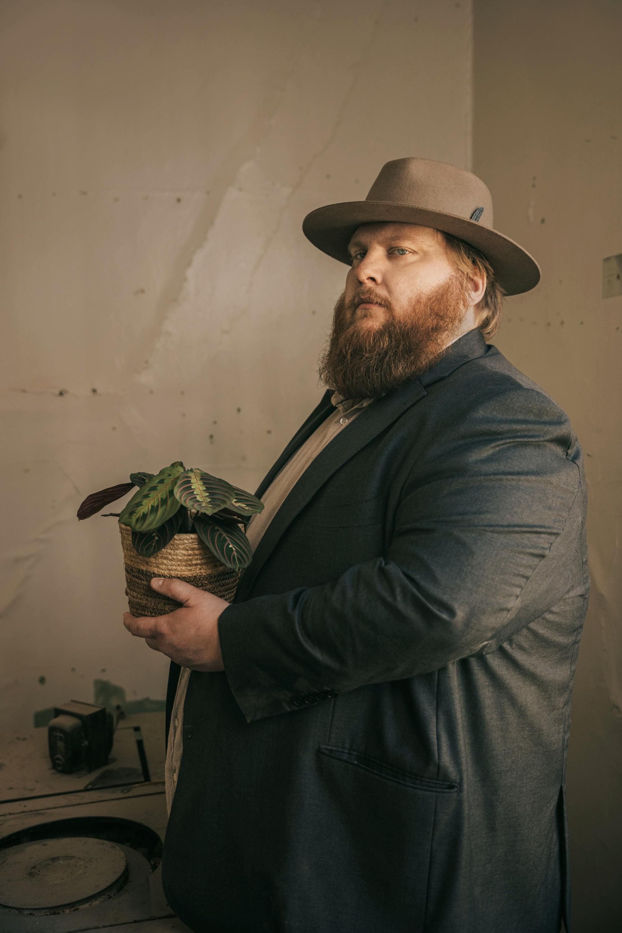 Icelandic singer Valdimar of Lón holding a plant