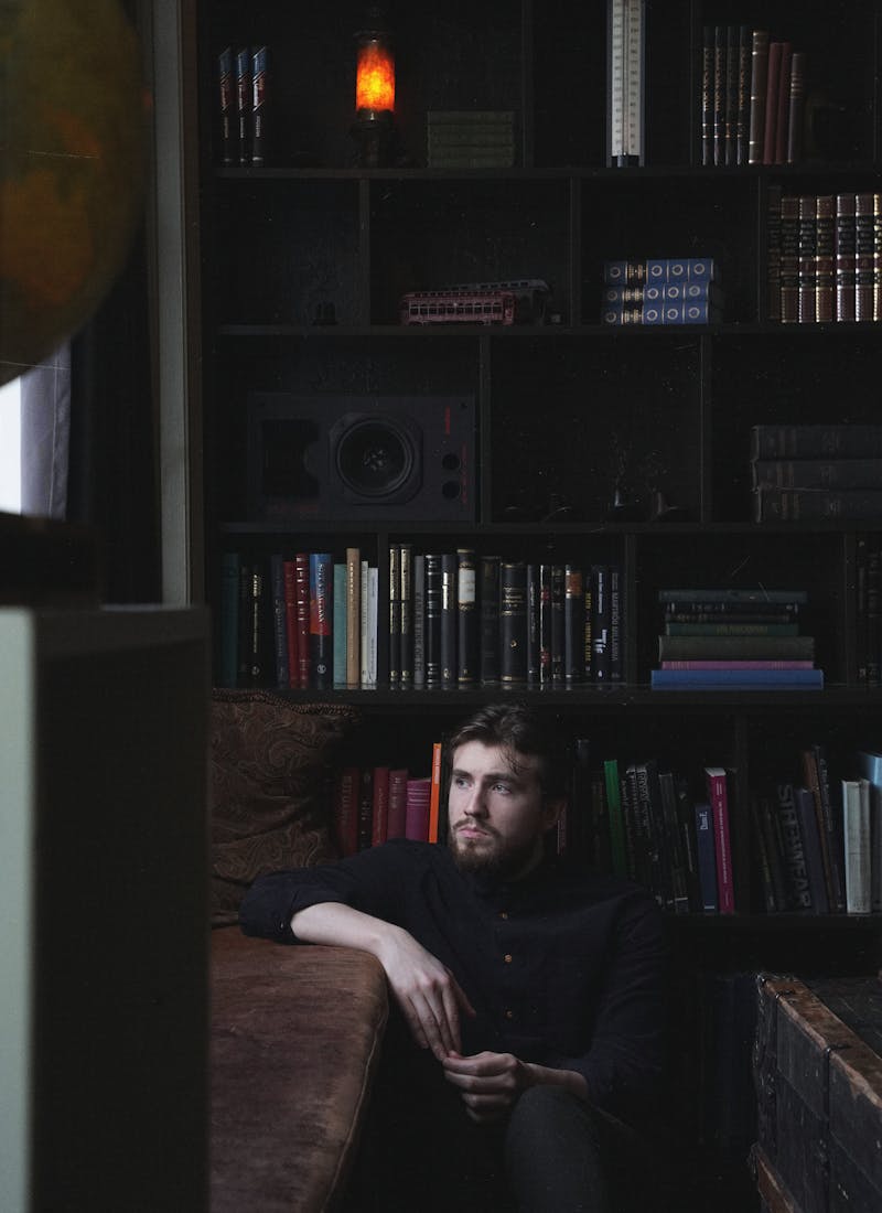Icelandic musician Axel Flovent by a bookshelf