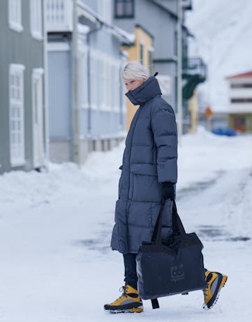 Girl walking in snowy condition in 66 degrees north clothing