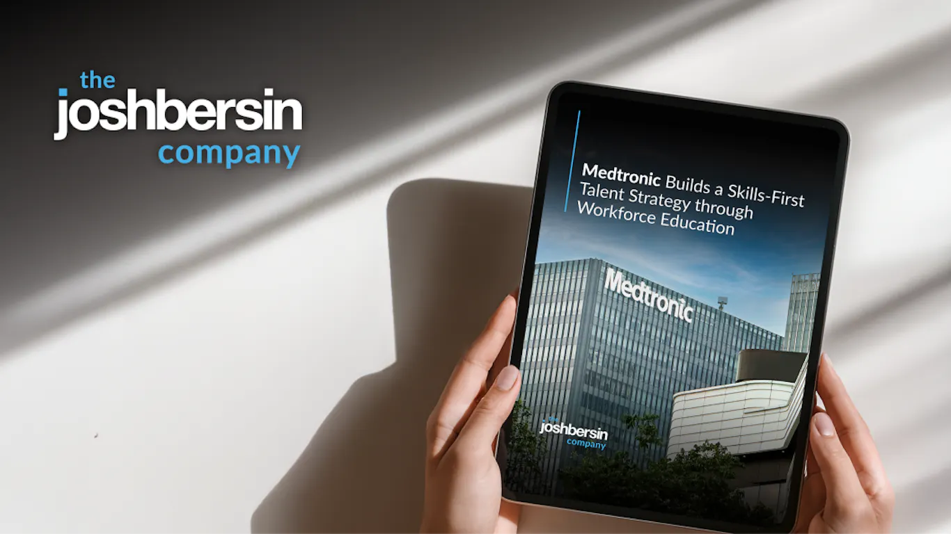 Person holding a tablet displaying the case study titled Medtronic builds a skills-first talent strategy through workforce education. Study completed by the Josh Bersin Company.