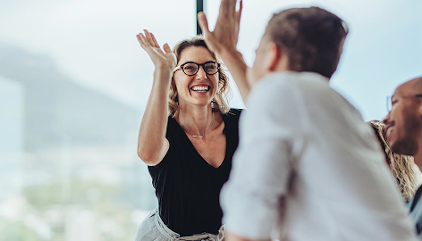 stock photo showing two people high fiving