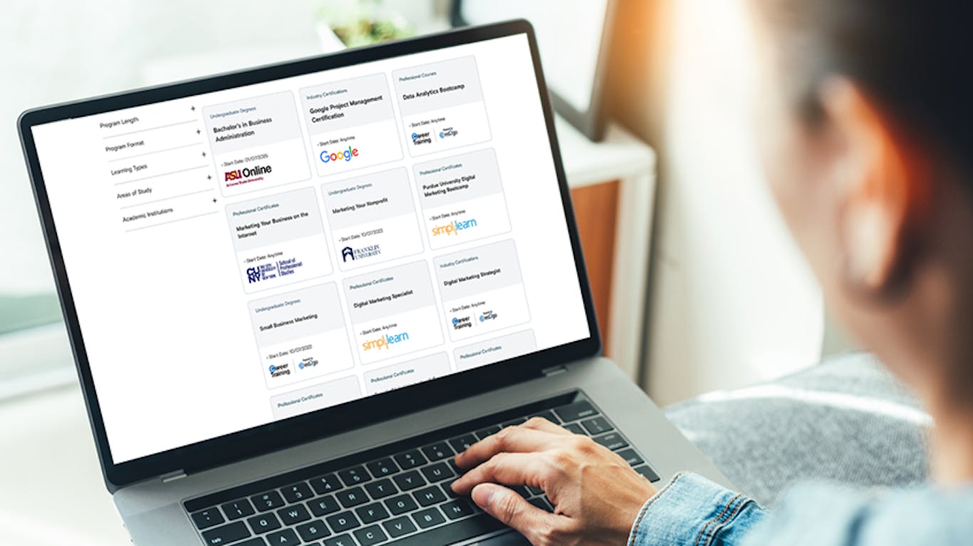 an employee browsing different courses and programs on a laptop