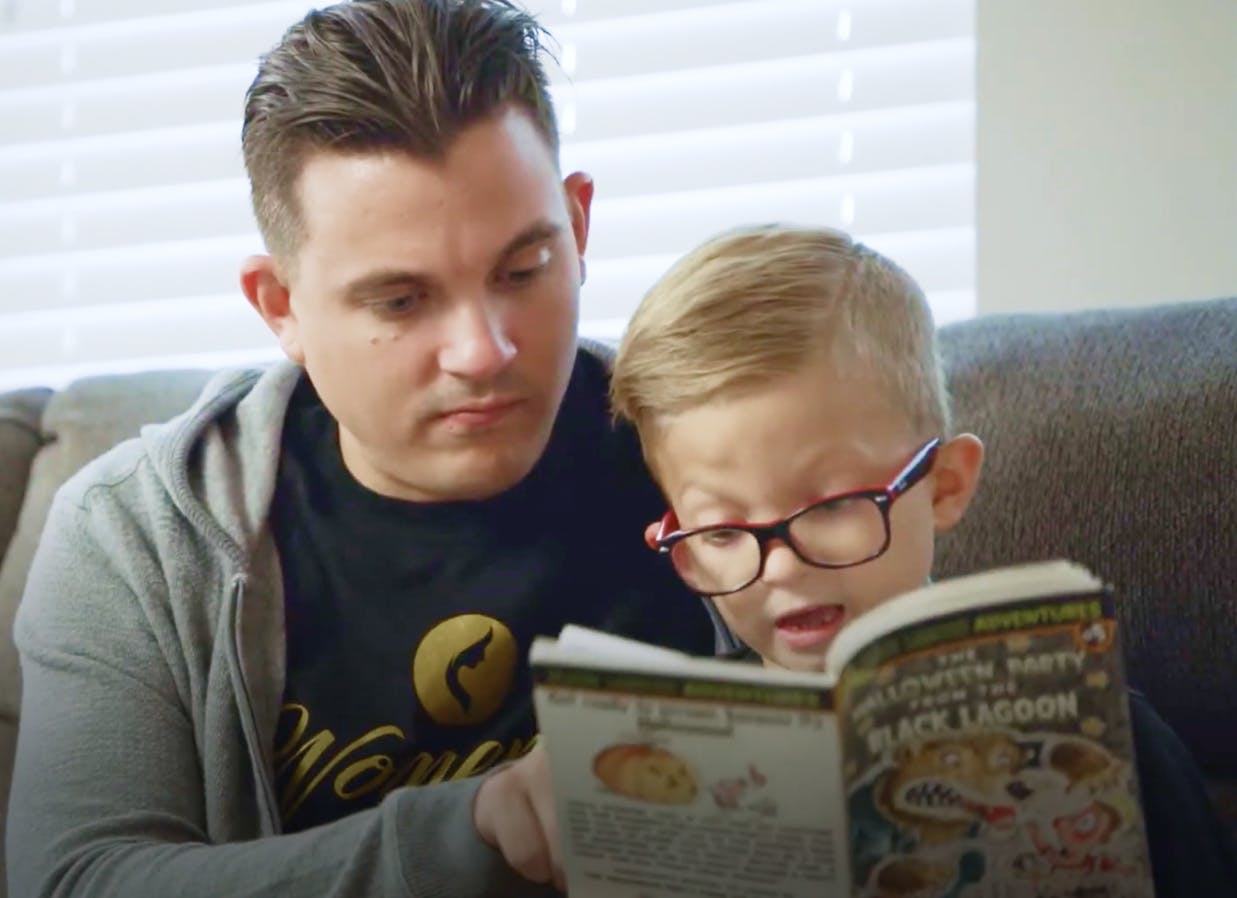 employee learner reading a book to his kid