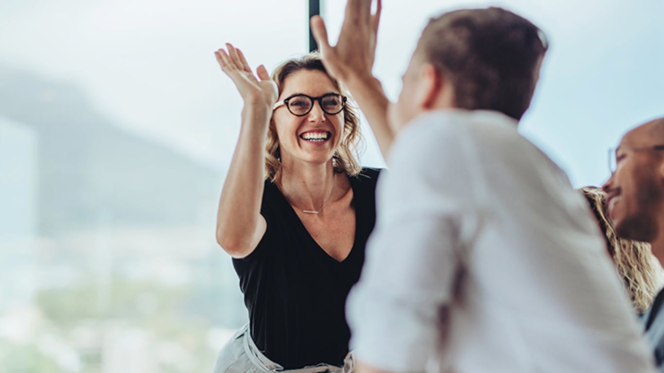 two people high fiving each other