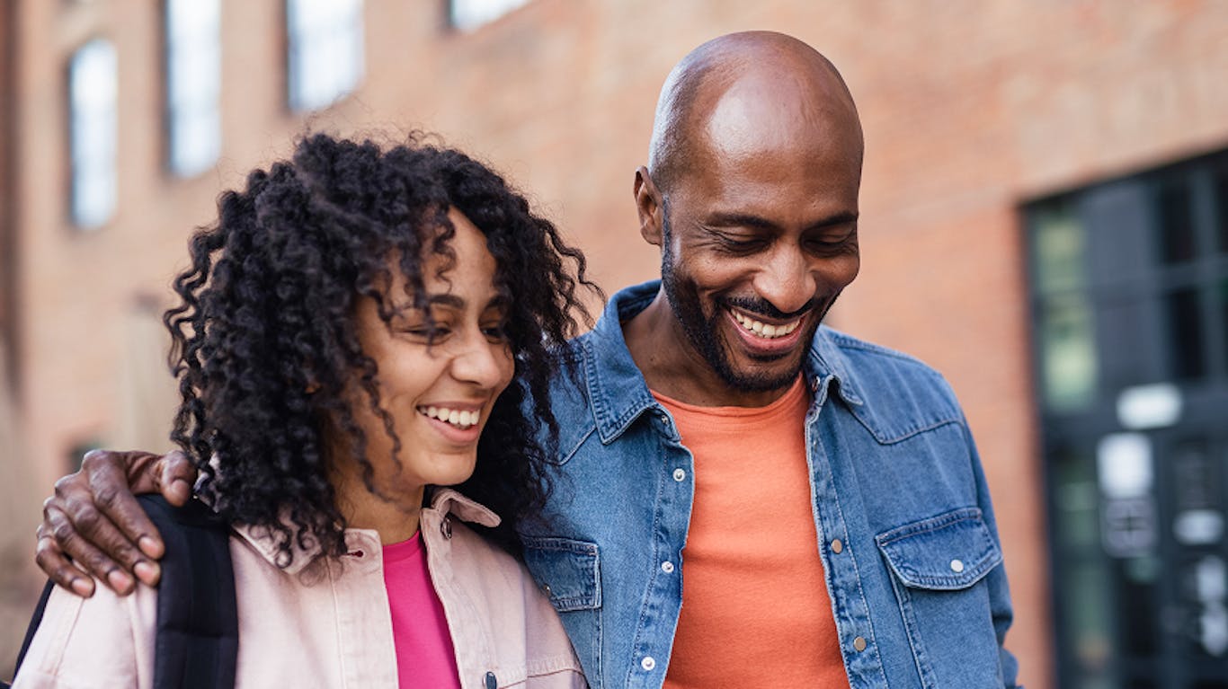 two family members walking together and smiling