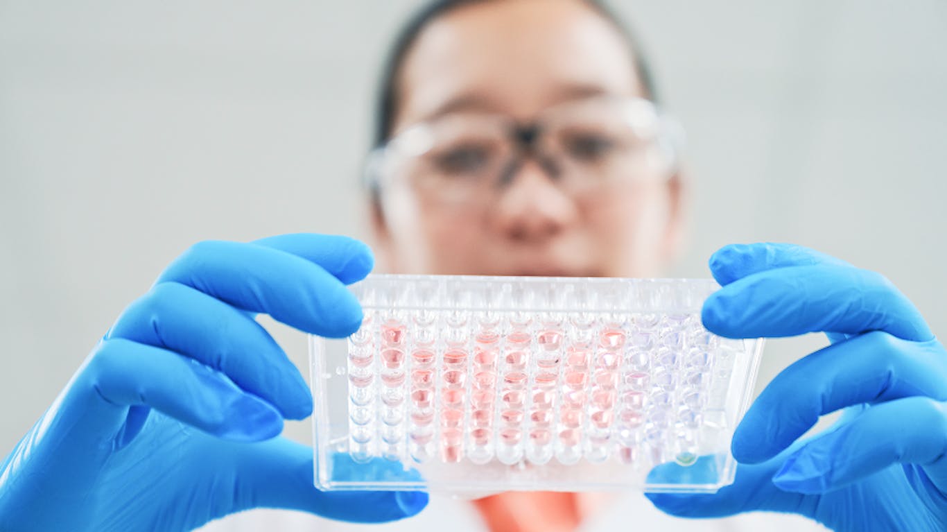 woman working in a lab looking down at a test