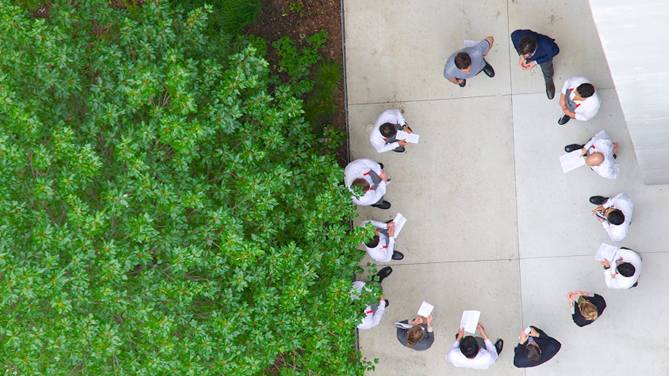 people standing in a circle working together