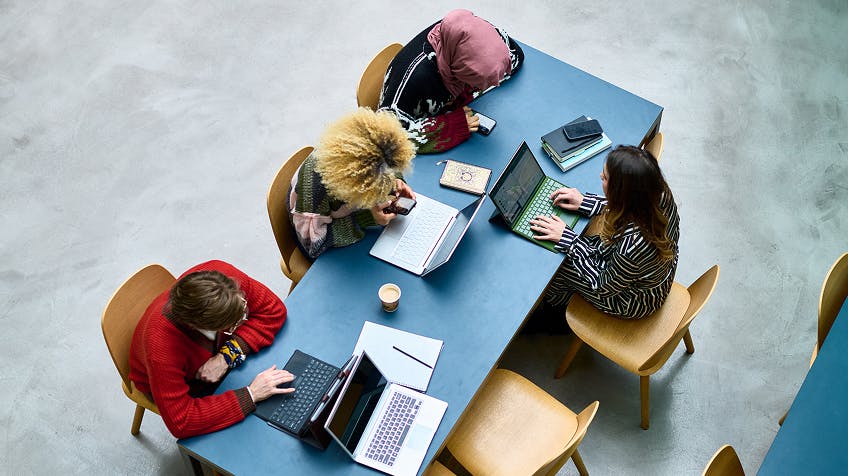 people working at a table together