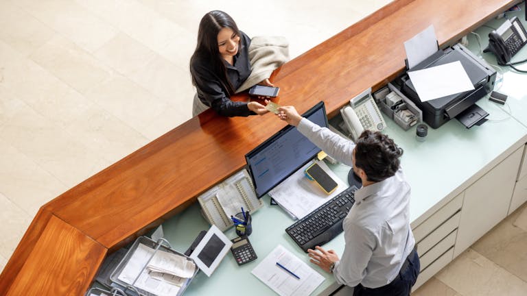 a bank teller interacting with a customer