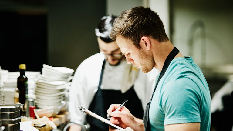 two men working in a restaurant