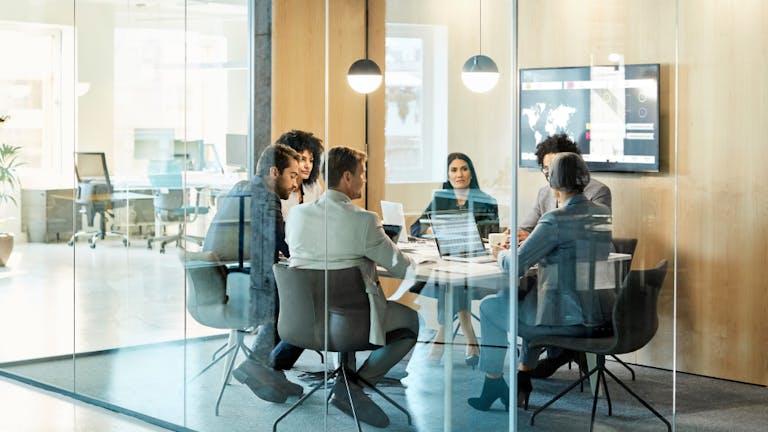a group of corporate employees at work around a table